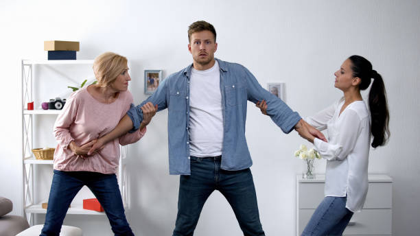 In-law conflict, mother and wife pulling young man in different directions